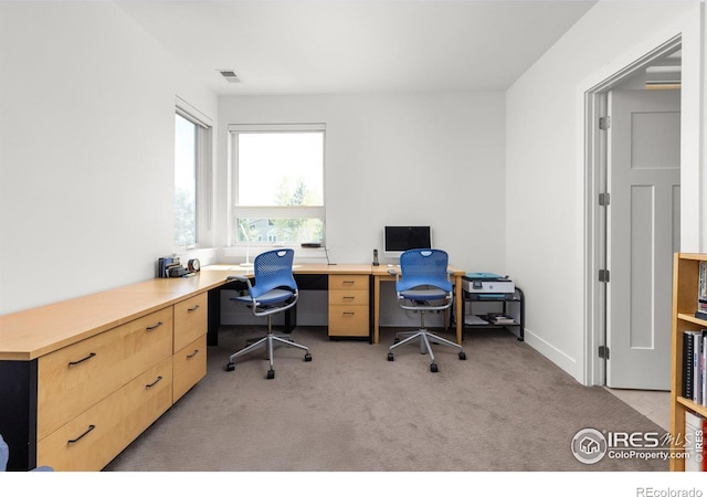 office area featuring visible vents and light colored carpet