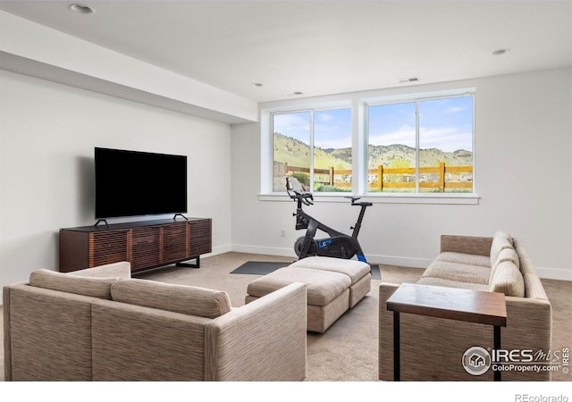 carpeted living area featuring visible vents and baseboards
