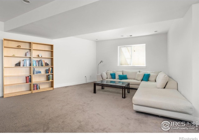 carpeted living area featuring baseboards