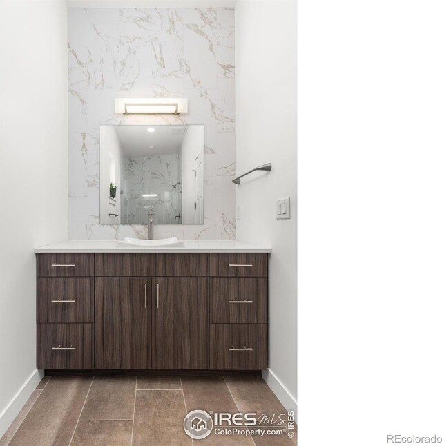 bathroom with baseboards and vanity