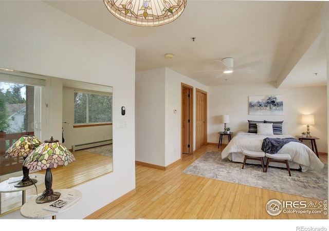 1460 Quince Ave Unit S102, Boulder, CO 80304 - bedroom featuring a baseboard radiator, hardwood / wood-style floors, and baseboards