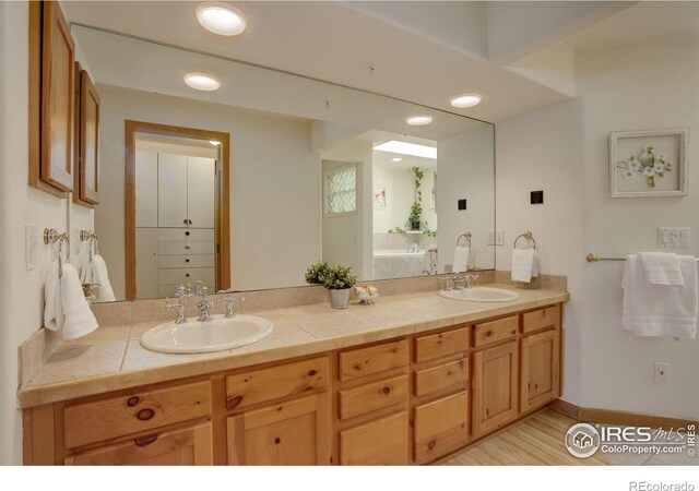 1460 Quince Ave Unit S102, Boulder, CO 80304 - full bathroom featuring double vanity, wood finished floors, and a garden tub