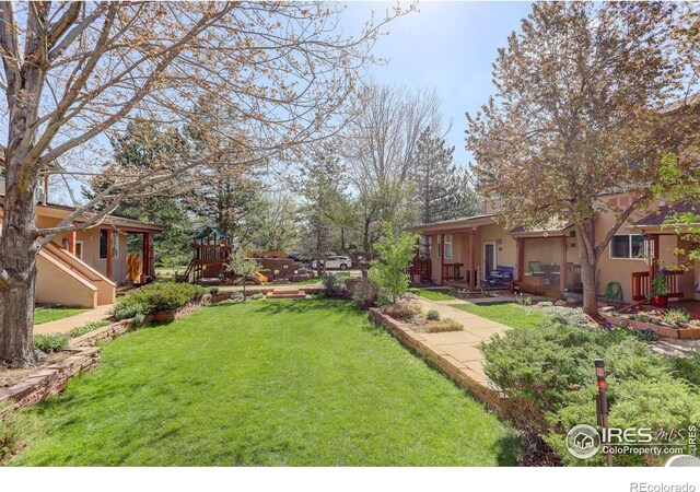 1460 Quince Ave Unit S102, Boulder, CO 80304 - view of grassy yard featuring a patio and a playground