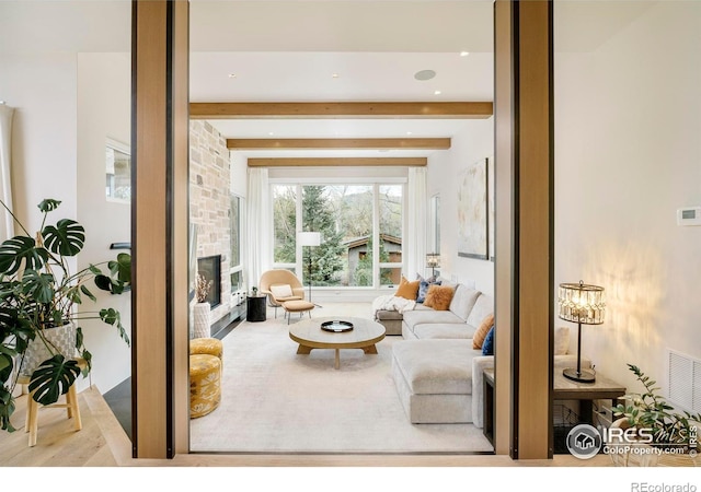 2158 Tamarack Ave, Boulder, CO 80304 - living room with beam ceiling, a stone fireplace, recessed lighting, wood finished floors, and visible vents