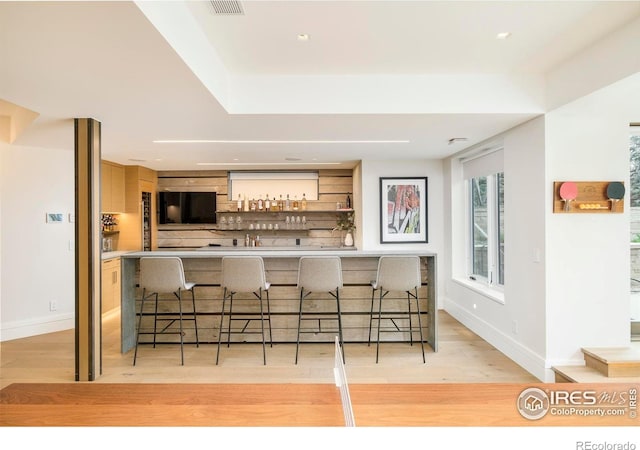 2158 Tamarack Ave, Boulder, CO 80304 - kitchen featuring visible vents, open shelves, a breakfast bar, baseboards, and light wood-style flooring