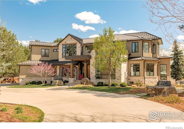 2158 Tamarack Ave, Boulder, CO 80304 - view of front of home with curved driveway, a standing seam roof, metal roof, and stone siding