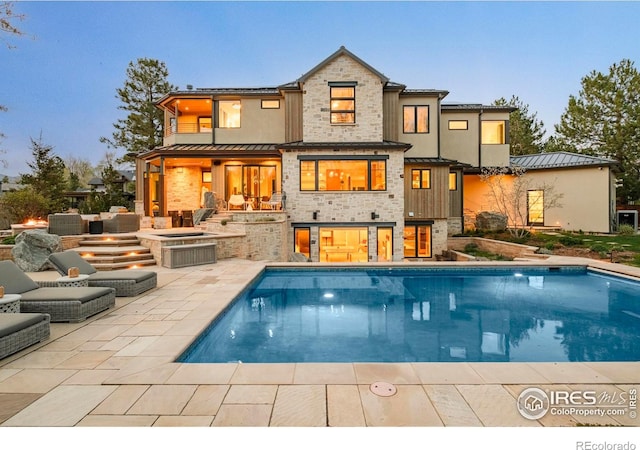 2158 Tamarack Ave, Boulder, CO 80304 - rear view of property with a patio, a standing seam roof, an outdoor pool, and stone siding