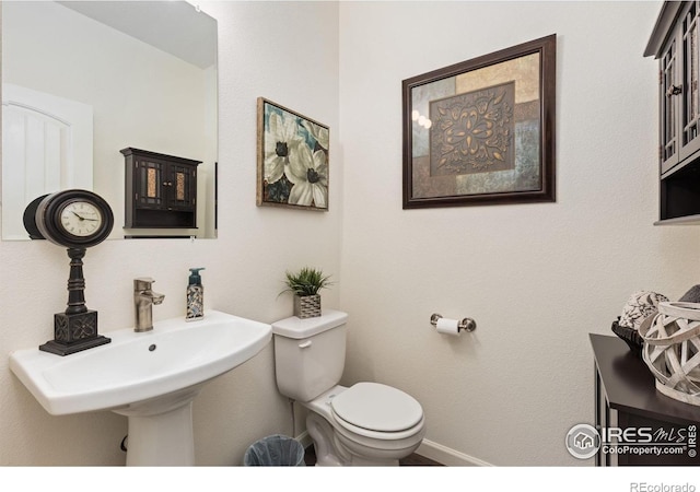 4355 24th Street Rd Unit 202, Greeley, CO 80634 - bathroom featuring baseboards and toilet