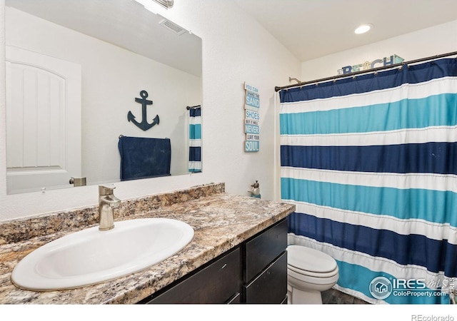 4355 24th Street Rd Unit 202, Greeley, CO 80634 - bathroom with vanity, a shower with shower curtain, toilet, and visible vents