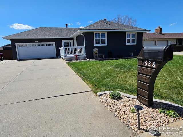 1628 Pheasant Rdg, Sterling, CO 80751 - ranch-style home featuring a shingled roof, a garage, stucco siding, a front yard, and concrete driveway