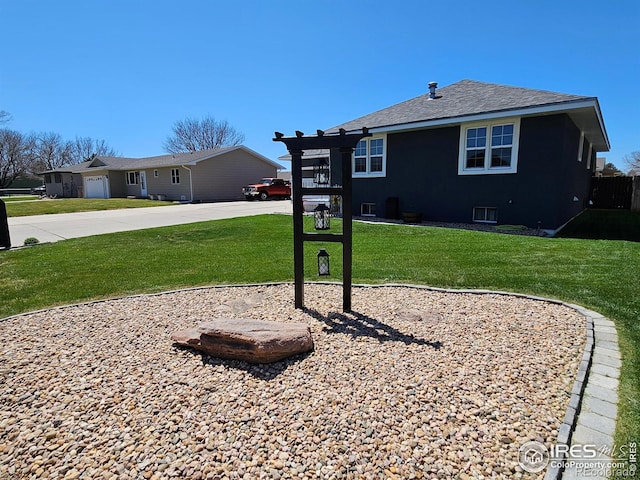 1628 Pheasant Rdg, Sterling, CO 80751 - exterior space with a shingled roof, a yard, and driveway