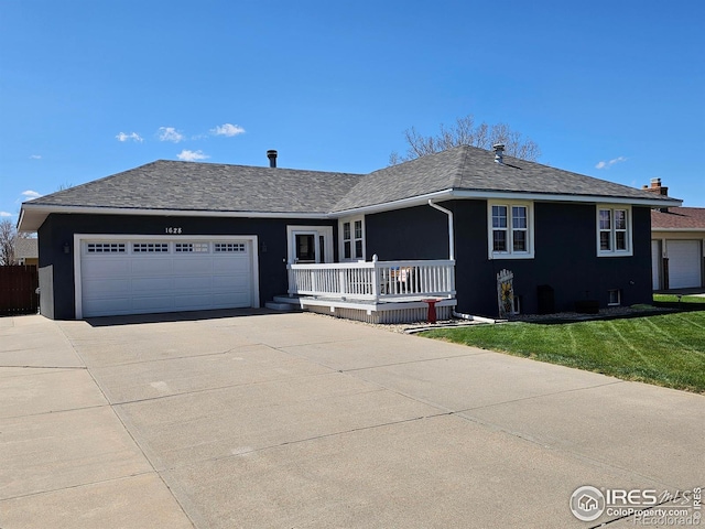 1628 Pheasant Rdg, Sterling, CO 80751 - ranch-style home with a porch, a front yard, a garage, concrete driveway, and stucco siding