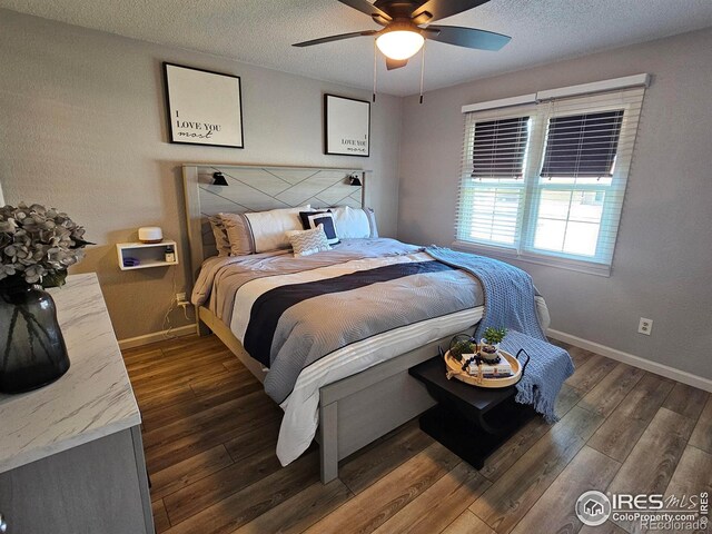 1628 Pheasant Rdg, Sterling, CO 80751 - bedroom with a textured ceiling, baseboards, and dark wood finished floors