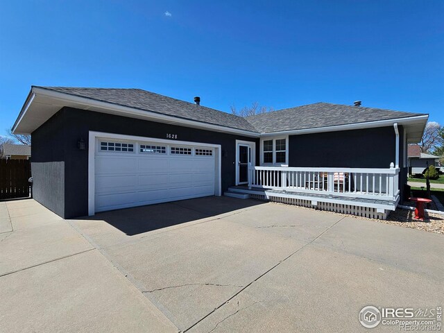 1628 Pheasant Rdg, Sterling, CO 80751 - single story home featuring a porch, driveway, a shingled roof, and a garage