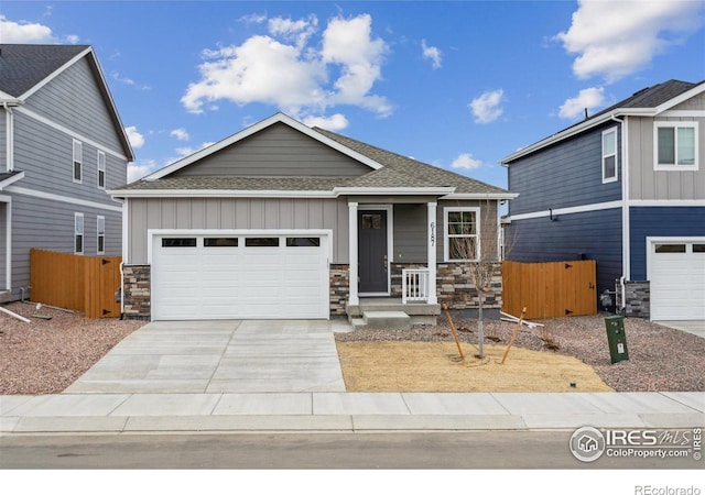 6500 13th St, Frederick, CO 80530 - craftsman inspired home featuring stone siding, roof with shingles, driveway, a garage, and board and batten siding