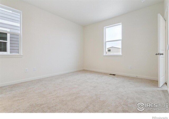 6500 13th St, Frederick, CO 80530 - carpeted empty room with baseboards