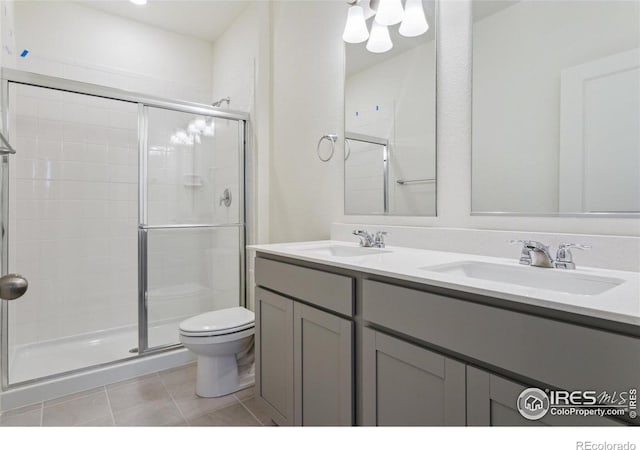 6500 13th St, Frederick, CO 80530 - bathroom with toilet, a stall shower, tile patterned floors, and double vanity