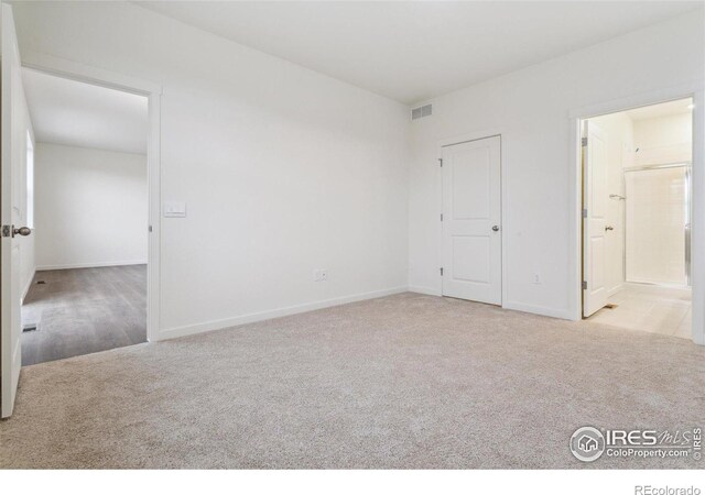 6500 13th St, Frederick, CO 80530 - unfurnished bedroom featuring carpet flooring, baseboards, and ensuite bathroom