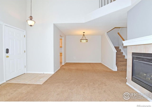 2203 Copper Creek Dr Unit D, Fort Collins, CO 80528 - entrance foyer featuring carpet, a fireplace, a high ceiling, and stairway