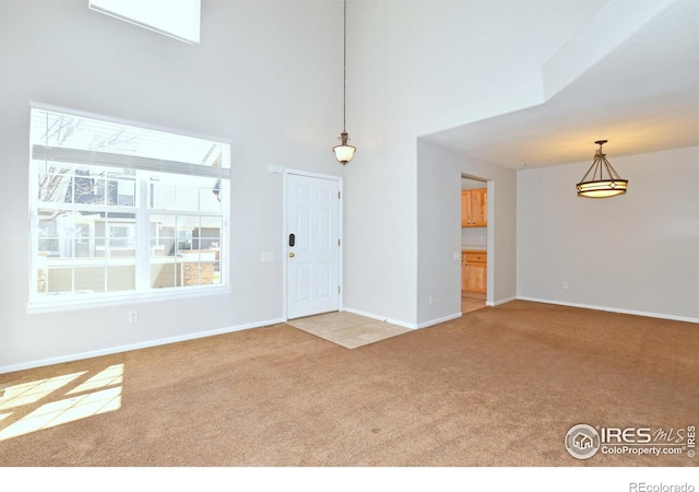 2203 Copper Creek Dr Unit D, Fort Collins, CO 80528 - foyer featuring baseboards, a high ceiling, and carpet