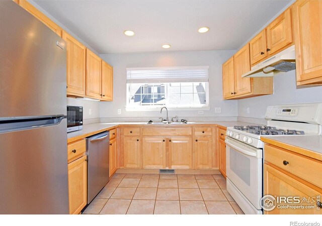 2203 Copper Creek Dr Unit D, Fort Collins, CO 80528 - kitchen featuring under cabinet range hood, stainless steel appliances, a sink, and light brown cabinets