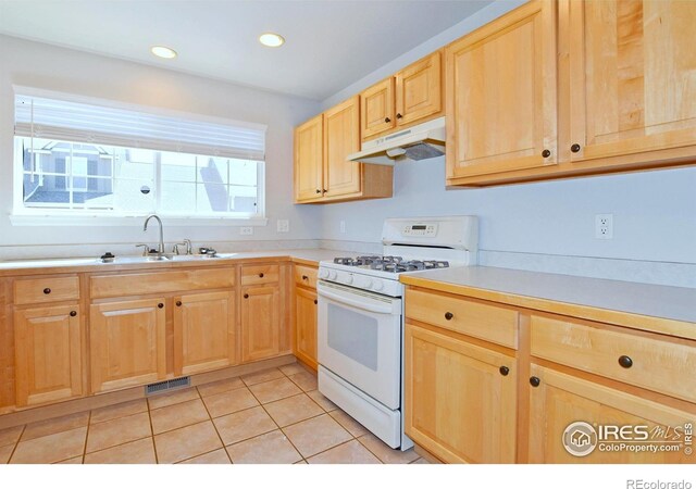 2203 Copper Creek Dr Unit D, Fort Collins, CO 80528 - kitchen featuring a sink, light brown cabinets, white gas range, under cabinet range hood, and visible vents