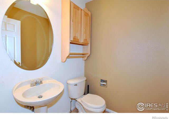 2203 Copper Creek Dr Unit D, Fort Collins, CO 80528 - bathroom with a sink, baseboards, and toilet