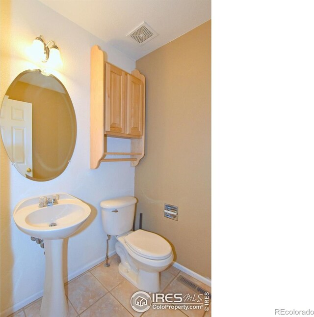 2203 Copper Creek Dr Unit D, Fort Collins, CO 80528 - half bath with visible vents, baseboards, tile patterned flooring, and toilet