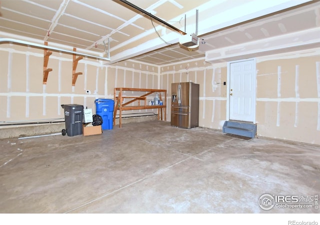 2203 Copper Creek Dr Unit D, Fort Collins, CO 80528 - garage with stainless steel fridge and a garage door opener