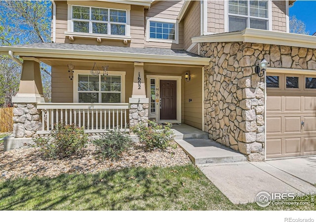 1602 Prairie Song Pl, Longmont, CO 80504 - property entrance with covered porch, roof with shingles, and stone siding