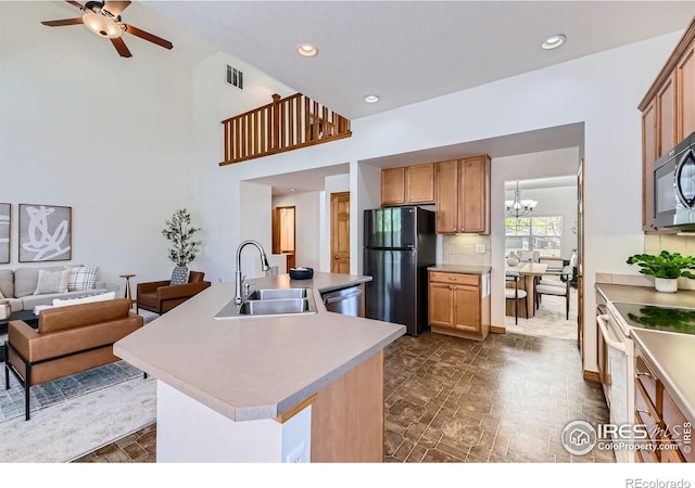 1602 Prairie Song Pl, Longmont, CO 80504 - kitchen featuring a sink, open floor plan, visible vents, a center island with sink, and black appliances