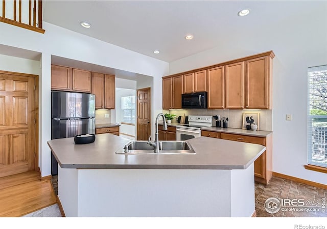 1602 Prairie Song Pl, Longmont, CO 80504 - kitchen featuring black microwave, white electric range oven, backsplash, and a sink