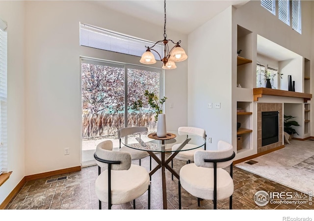 1602 Prairie Song Pl, Longmont, CO 80504 - dining space with stone finish flooring, a notable chandelier, and a healthy amount of sunlight