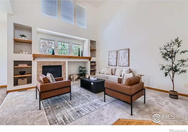 1602 Prairie Song Pl, Longmont, CO 80504 - carpeted living area with baseboards, built in features, and a fireplace