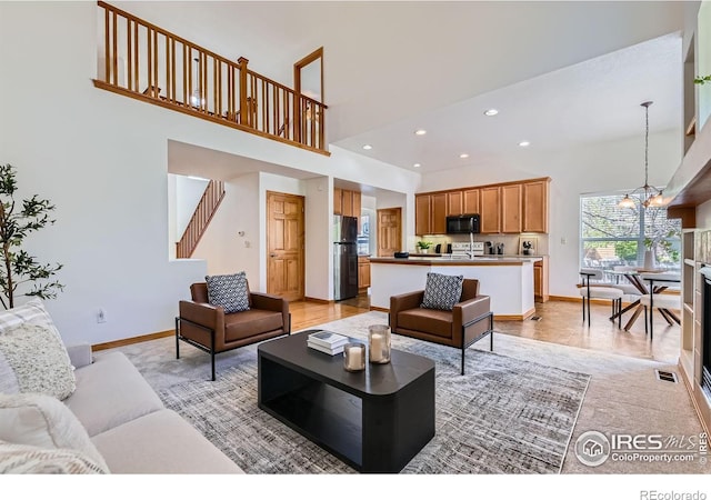 1602 Prairie Song Pl, Longmont, CO 80504 - living area with visible vents, a towering ceiling, stairs, baseboards, and recessed lighting