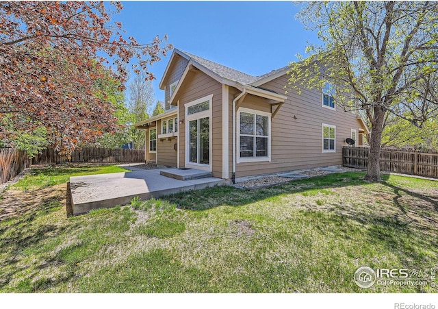 1602 Prairie Song Pl, Longmont, CO 80504 - back of property with a yard, a patio, and a fenced backyard