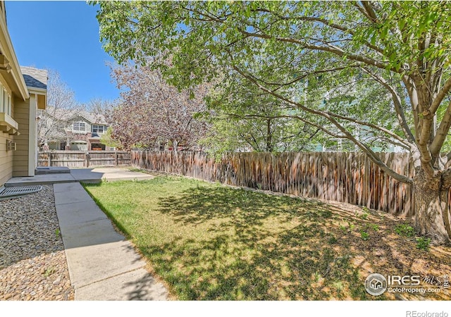 1602 Prairie Song Pl, Longmont, CO 80504 - view of yard featuring a fenced backyard and a patio area