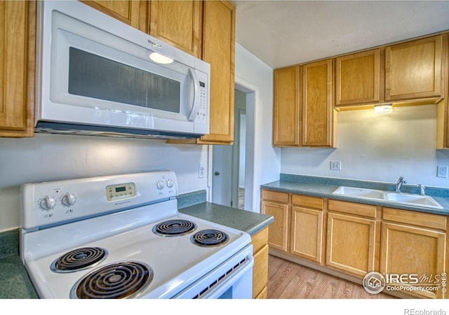 810 34th St, Boulder, CO 80303 - kitchen with white appliances, dark countertops, a sink, and light wood-style floors