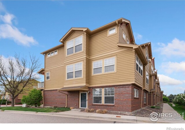 12820 King St, Broomfield, CO 80020 - view of property featuring brick siding