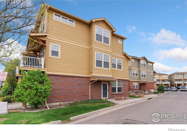 12820 King St, Broomfield, CO 80020 - view of front of house with brick siding and a residential view