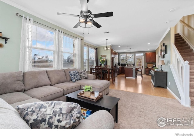 12820 King St, Broomfield, CO 80020 - living room with stairway, a ceiling fan, ornamental molding, recessed lighting, and baseboards