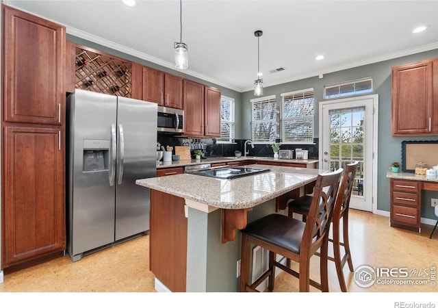 12820 King St, Broomfield, CO 80020 - kitchen with stainless steel appliances, crown molding, backsplash, pendant lighting, and a sink