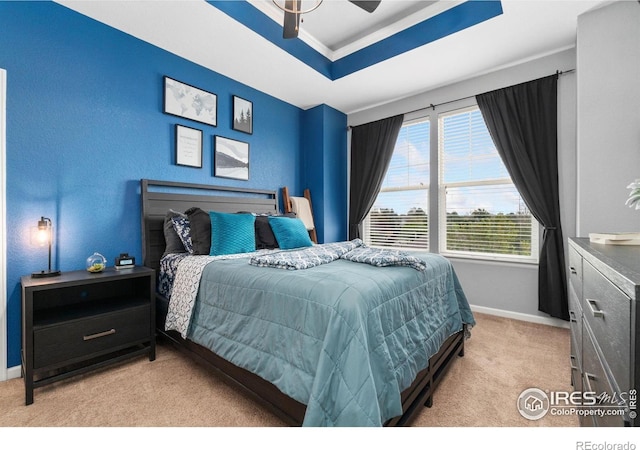 12820 King St, Broomfield, CO 80020 - bedroom featuring light carpet, baseboards, a tray ceiling, crown molding, and ceiling fan