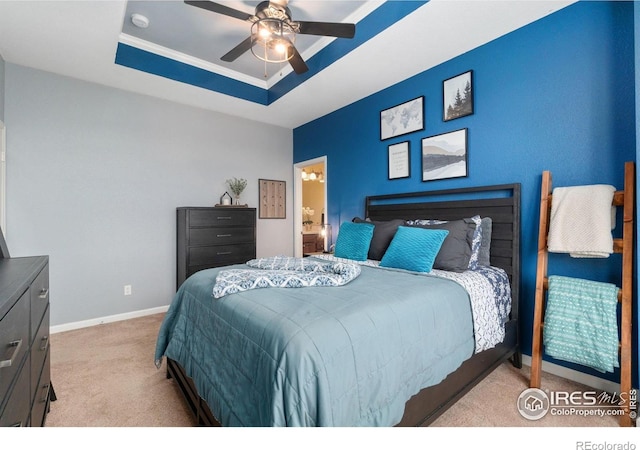 12820 King St, Broomfield, CO 80020 - carpeted bedroom with a tray ceiling, baseboards, connected bathroom, and ceiling fan