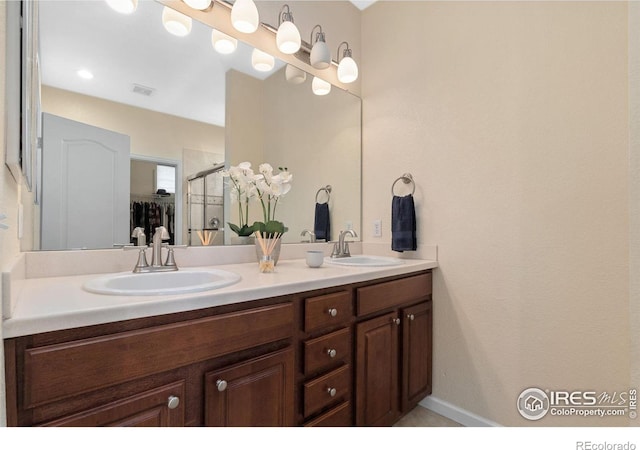 12820 King St, Broomfield, CO 80020 - bathroom featuring double vanity, a stall shower, and a walk in closet