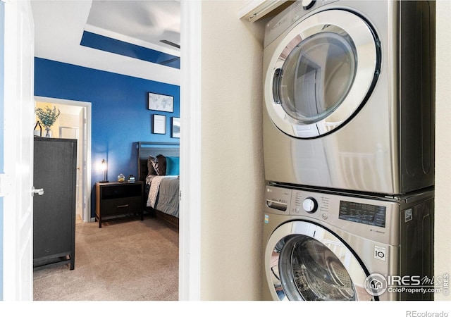 12820 King St, Broomfield, CO 80020 - washroom with stacked washing machine and dryer and carpet flooring