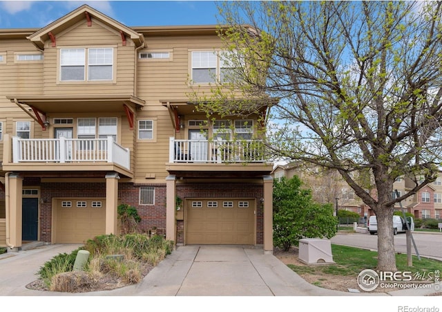12820 King St, Broomfield, CO 80020 - townhome / multi-family property with an attached garage, a balcony, driveway, and brick siding