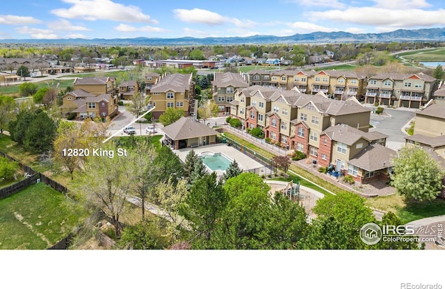 12820 King St, Broomfield, CO 80020 - aerial view of residential area with mountains and a pool