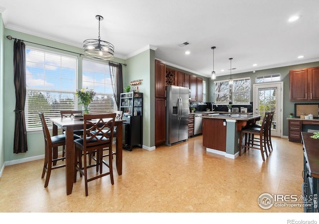 12820 King St, Broomfield, CO 80020 - kitchen featuring appliances with stainless steel finishes, a breakfast bar area, recessed lighting, baseboards, and crown molding