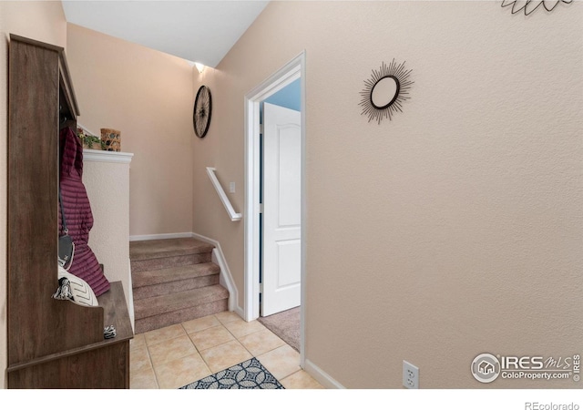 12820 King St, Broomfield, CO 80020 - stairway featuring carpet, tile patterned floors, and baseboards